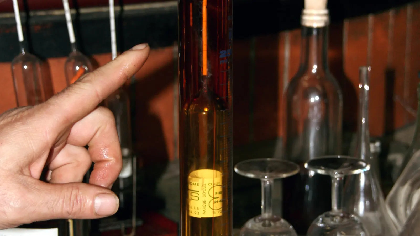 Alcoholmeter floating in a cylinder of distilled spirit for an ABV reading