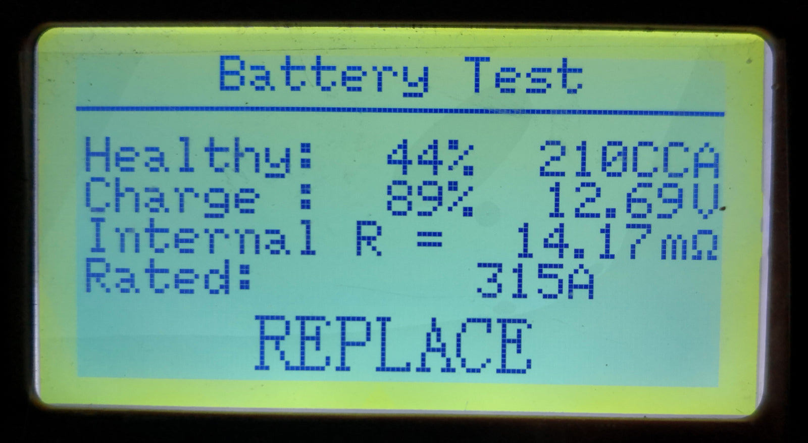 Automotive battery tester showing a replace result during diagnosis