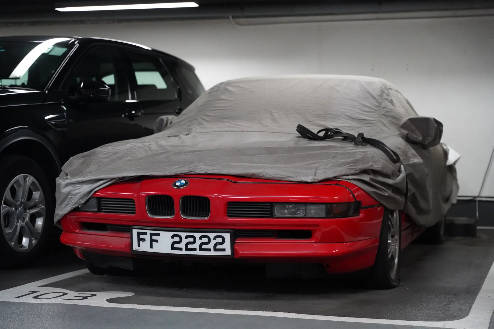 Covered car parked indoors during a long period of storage