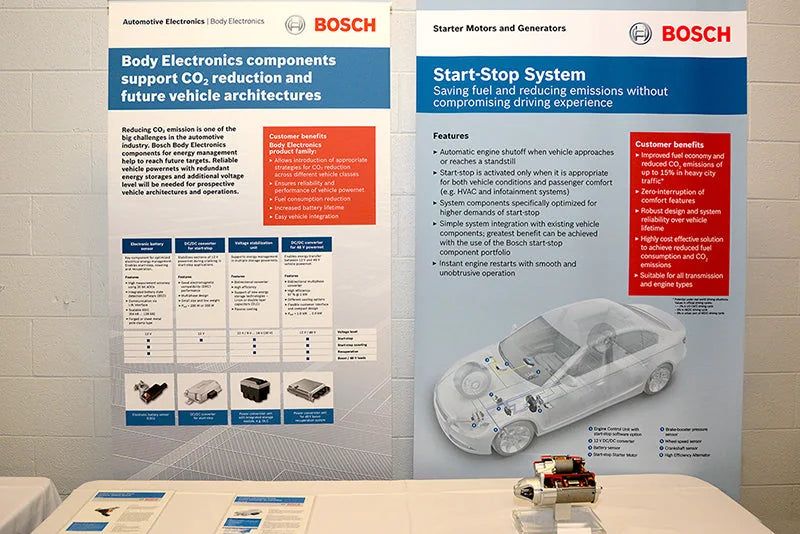 Photograph of a Bosch start-stop system exhibit with a starter motor and vehicle electronics display.
